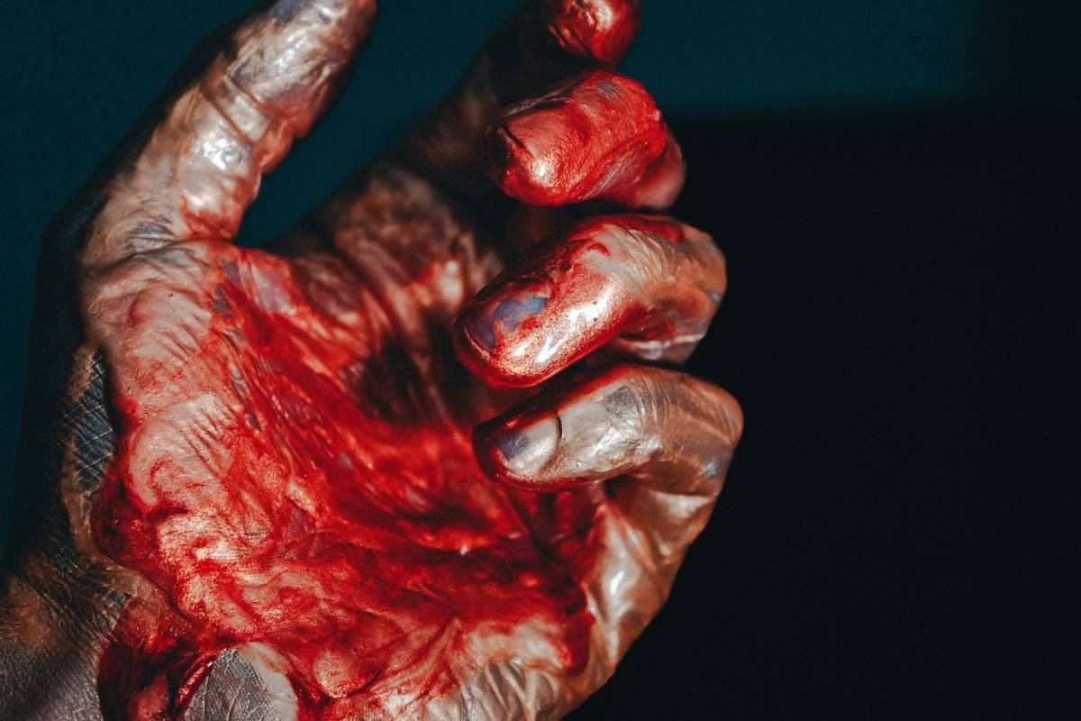 Close-up of realistic SFX makeup for wounds showing layered blood effect