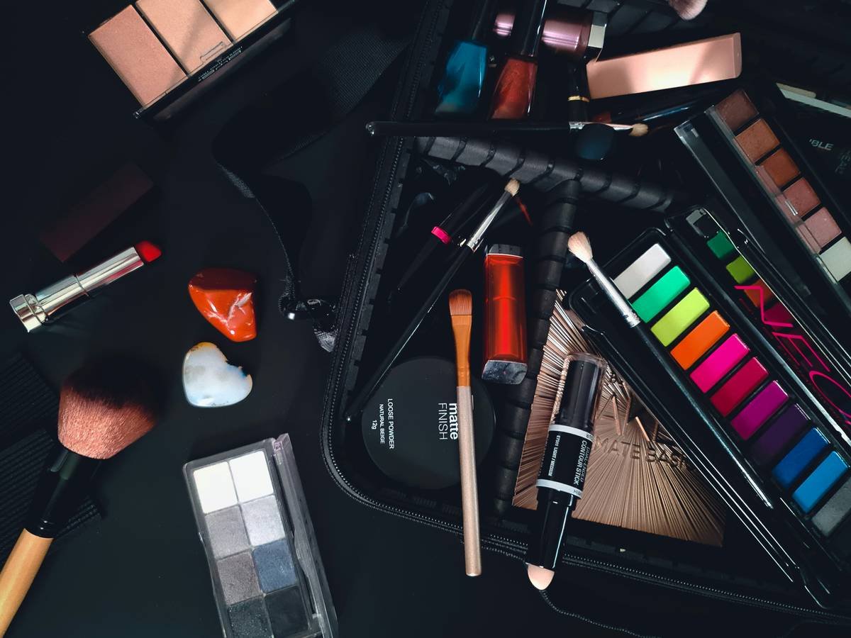 Professional applying stage makeup for professionals under theatrical lighting