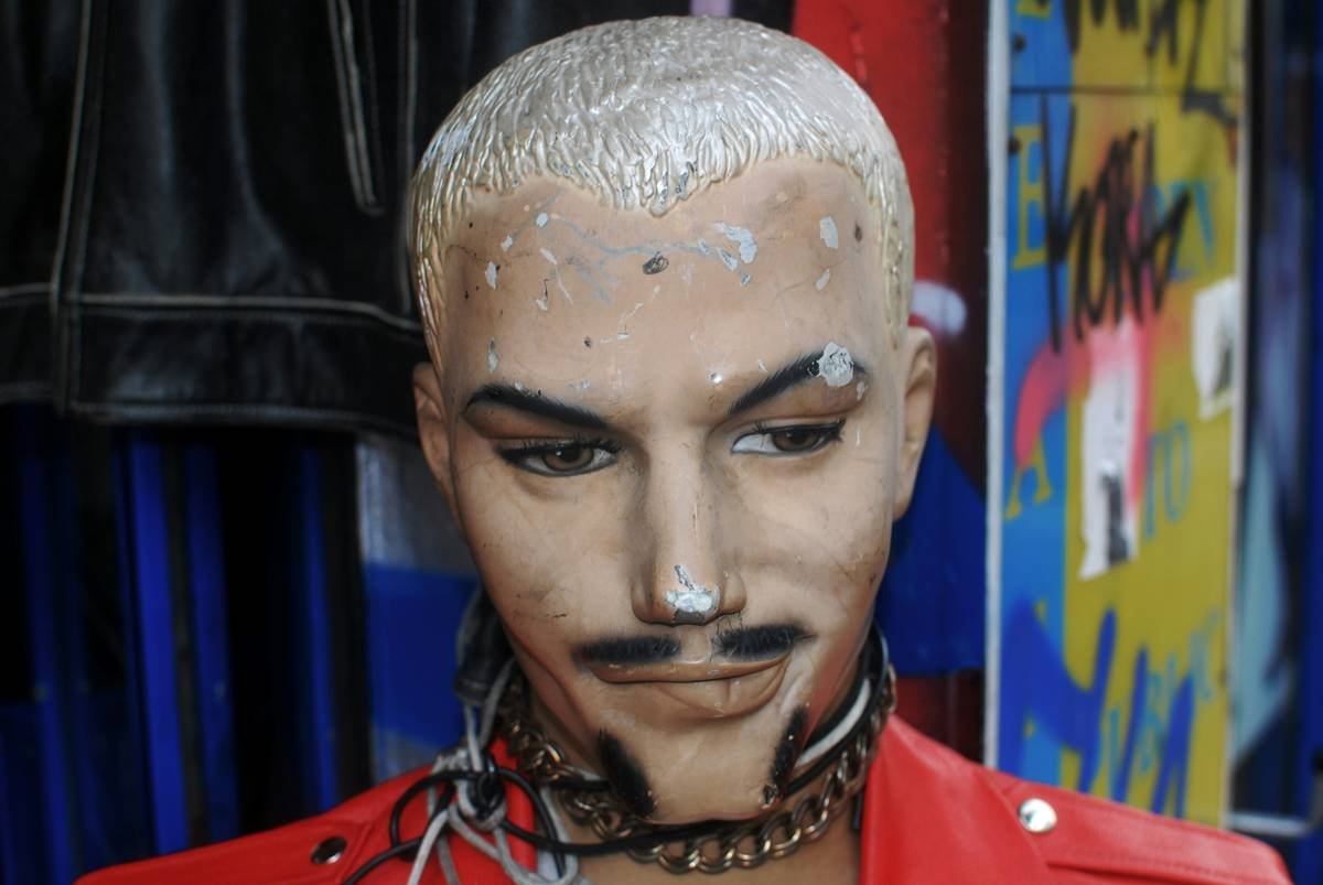 Close-up of intricate SFX makeup for monsters featuring textured scars and layered silicone prosthetics on human skin